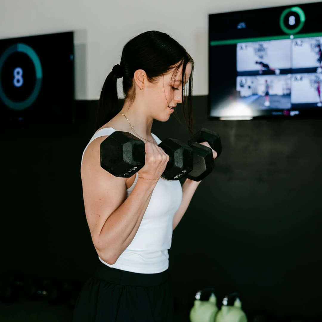 Member performs dumbbell curls